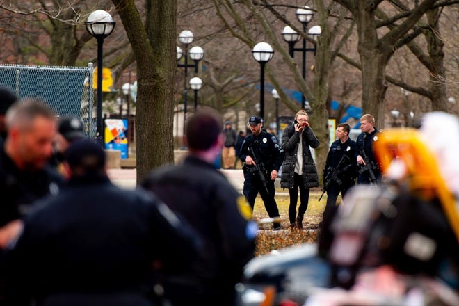 University of Michigan police officers respond with Washtenaw County Sheriff's deputies and the FBI, ATF and U.S. Border Patrol to a report of an active shooter on the University of Michigan campus near Mason Hall in Ann Arbor, Mich., Saturday, March 16, 2019.