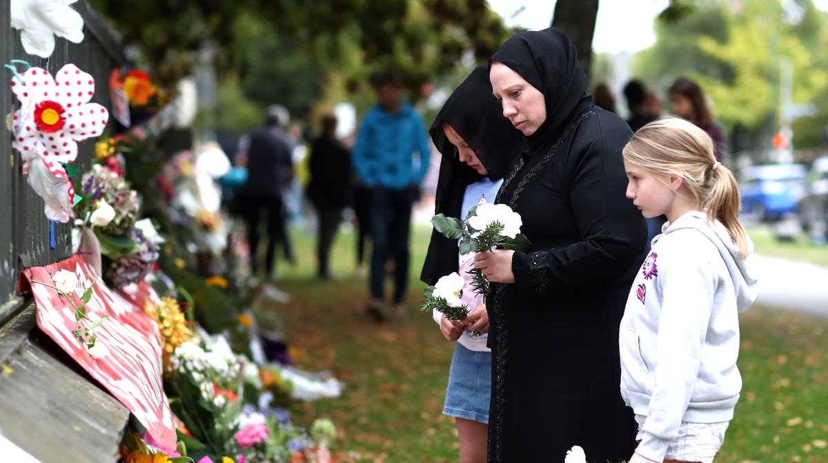 Members of the Muslim community lay flowers at the memorial wall at the Botanic Gardens on March 17, 2019 in Christchurch, New Zealand. 50 people are confirmed dead, with dozens injured still in hospital following shooting attacks on two mosques in Christchurch on Friday, March 15th.