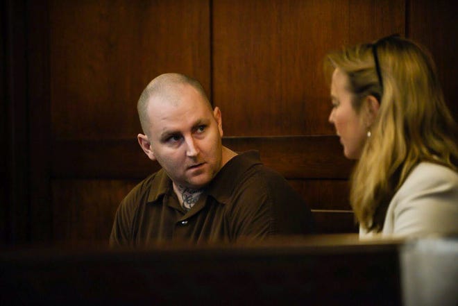 James Michael Norton, 33, speaks with his attorney, LeAnn Melton, on March 18.