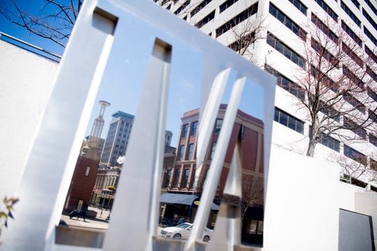 A view of Market Square reflected in the TVA sign in downtown Knoxville, Tennessee on Monday, March 18, 2019.