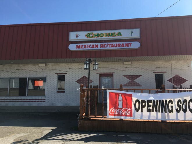 A sign reading "Opening Soon" hangs from space expected to house a Cholula Mexican Restaurant.