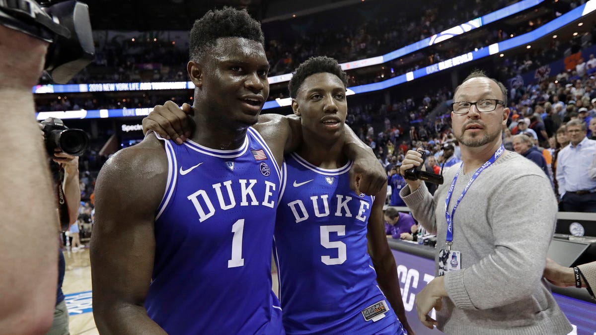 Duke's Zion Williamson (1) and R.J. Barrett (5) embrace as they leave the court after Duke defeated North Carolina in an NCAA college basketball game in the Atlantic Coast Conference tournament.