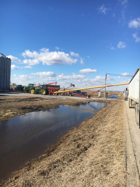 Neighbors rallied to help western Iowa farmer Jeff Jorgenson move stored corn and soybeans threatened by flooding.