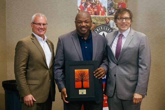 Eldonta Osborne (center) recently was named the national recipient of the Boys & Girls Club’s Herman S. Prescott Award. Osborne was presented the award by Drake Mills (left), president of the North Central Boys & Girls Club Board, and Joe Ethier (right) Director of Organizational Development for Boys & Girls Club of America.