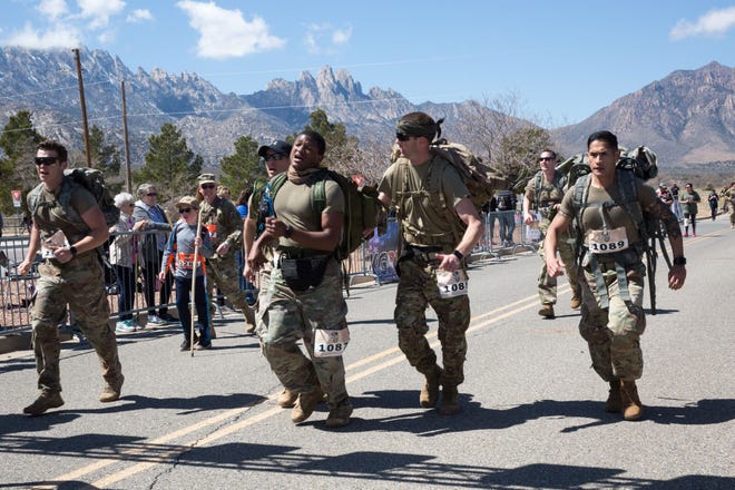 Teammates push each other to reach the finish line at the 30th Bataan Memorial Death March on Sunday, March 17, 2019.