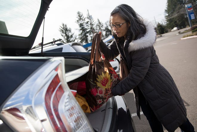 Vicky Garnier, of Salem, places her reusable bags in her car after grocery shopping March 2019. Garnier said she has been using reusable bags for more than 10 years.