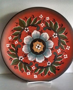 Jerry Apps' brother-in-law Clarence Olson did rosemaling on this plate. Rosemaling, a Norwegian folk art, is also known as rose painting and brightened many a household in Norway.