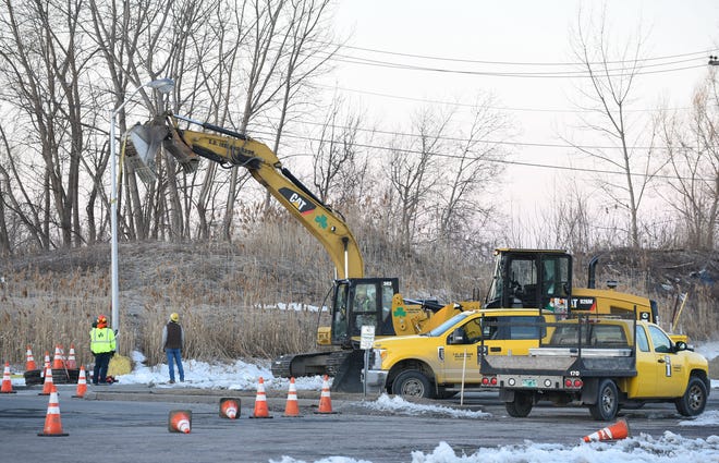 Workers remove a lamp post from the parking area of the former Kmart Plaza off Shelburne Road in South Burlington on the morning of Wednesday, March 20, 2019. Renovation work has begun at the empty shopping center to make way for a new Hannaford supermarket.