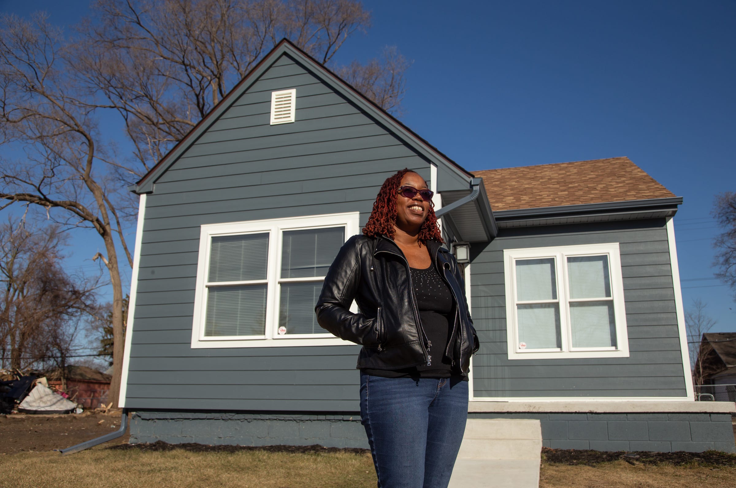 Jomica Miller stands in front of her house she recently purchased on Detroit's northwest side on Tuesday, March 12, 2019.