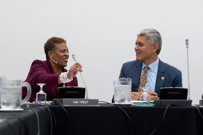 Wayne State University Board of Governors chair Kim Trent, left, and president Roy Wilson chat before the start of a Board of Governors meeting at Wayne State University.