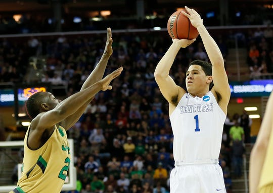 Wildcats guard Devin Booker (1) shoots over Notre Dame guard Jerian Grant (22) during the first half of an NCAA Tournament game in 2015.