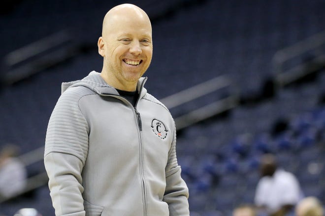 Cincinnati Bearcats head coach Mick Cronin shares a laugh with the team during stretch before open practice, Thursday, March 21, 2019, at Nationwide Arena in Columbus, Ohio. 