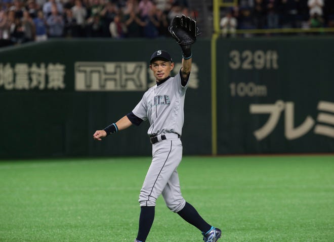 Mariners right fielder Ichiro Suzuki waves to spectators while leaving the field for defensive substitution in the eighth inning Thursday night in Tokyo. He was expected to announce his retirement after the game.