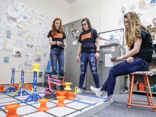 Left to right, Sydni Zebrauskas, Kaylee Rhoton, and Madyson Eshelman, from the The S.M.A.C.K. Attack all girl robotics team, practice driving their bot after school at Hamilton Heights Middle School in Arcadia Ind. on Tuesday, March 19, 2019. 