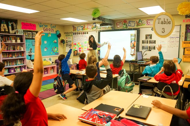 Twin sisters Taylor Wallace and Morgan Mercado share the same love for teaching at Woodvale Elementary School in Lafayette, Louisiana. Here, Mercado teachers her fourth-graders.