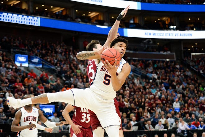 Auburn forward Chuma Okeke (5) brings down a rebound against New Mexico State forward Ivan Aurrecoechea (15) during the first round of the NCAA Tournament at Vivint Smart Home Arena on March 21, 2019, in Salt Lake City.