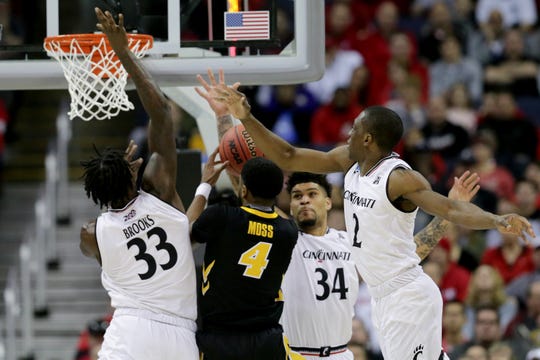 Iowa Hawkeyes guard Isaiah Moss (4) takes it to the basket as Cincinnati Bearcats center Nysier Brooks (33), Cincinnati Bearcats guard Jarron Cumberland (34) and Cincinnati Bearcats guard Keith Williams (2) defend in the first half of the NCAA Tournament Round of 64 game, Friday, March 22, 2019, at Nationwide Arena in Columbus, Ohio. 