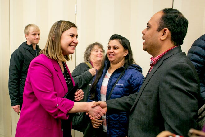 U.S. Rep. Elissa Slotkin greets constituents Pooja Sharma and her husband, Manoj Bhalerao, both of Rochester, at a town hall event at Oakland University in Rochester on Thursday, March 21.