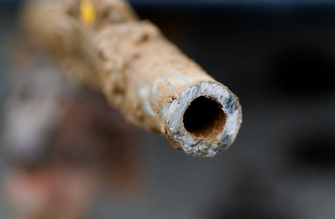 In this July 20, 2018 file photo, a lead pipe is shown after being replaced by a copper water supply line to a home in Flint.