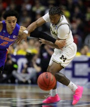Michigan's Zavier Simpson steals the ball from Andrew Nembhard of Florida in the first period.