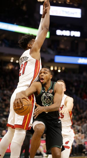 Sterling Brown passes around Miami's Hassan Whiteside during the second half of their game Friday night. Brown returned to action after missing 13 games over nearly a month with a right wrist injury.