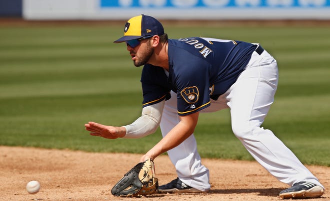 Brewers second baseman Mike Moustakas fields a ground ball for an out during a game against Texas in the third inning March 19.