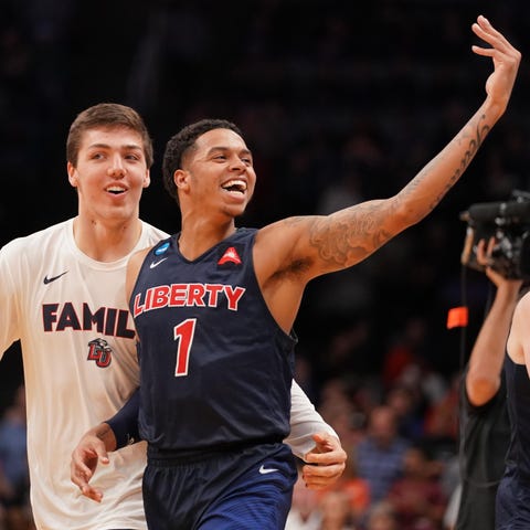Liberty's Caleb Homesley celebrates with...