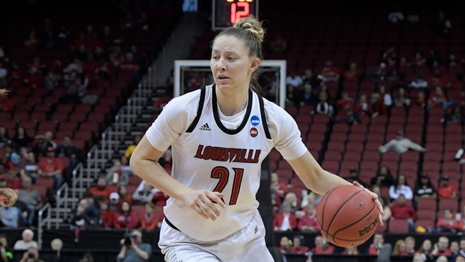 Louisville forward Kylee Shookbrings the ball up court.