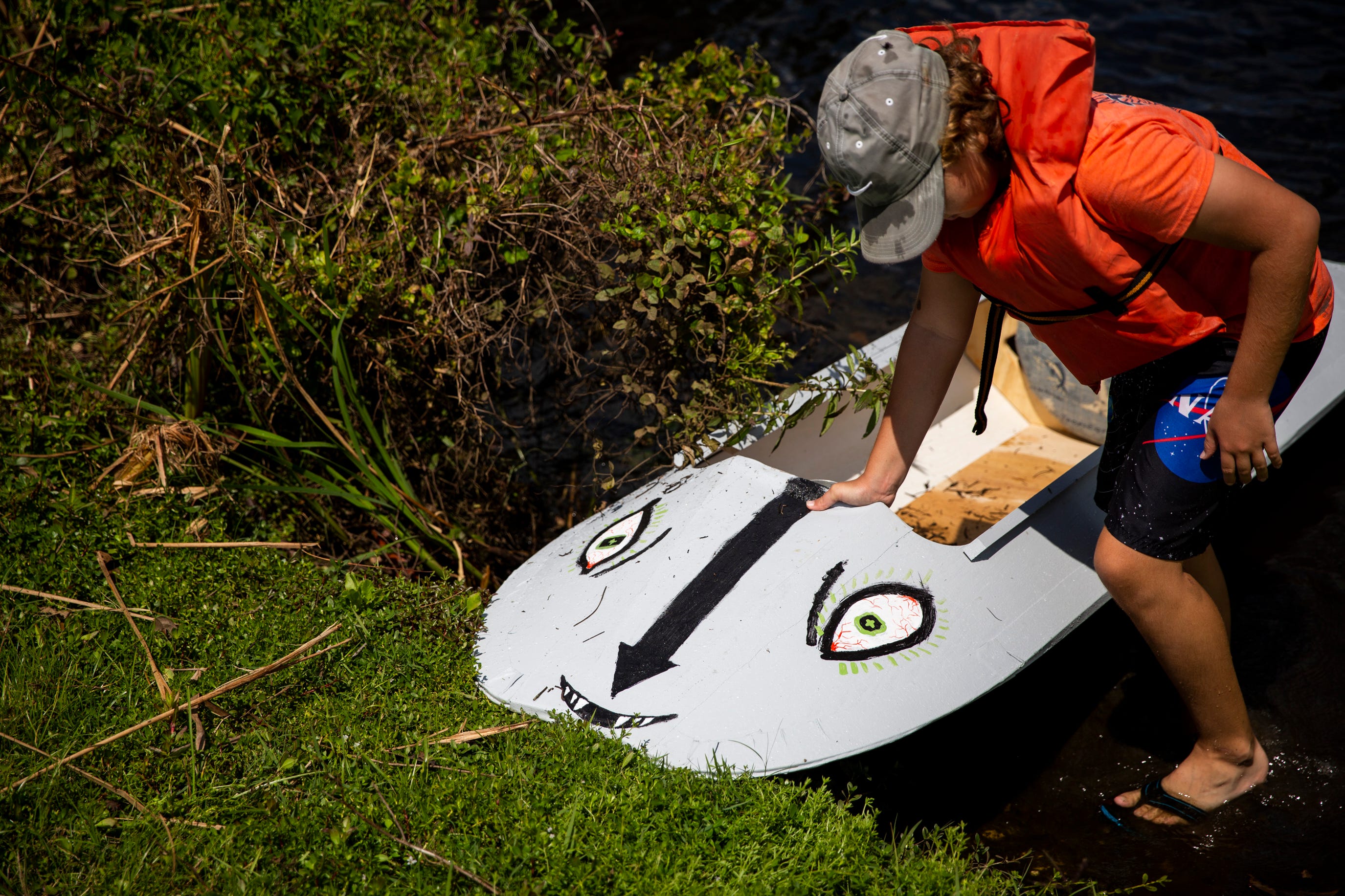 Larson Dyer pulls his kayak out of the Imperial River at Riverside Park in Bonita Springs on Sunday, March 24, 2019.