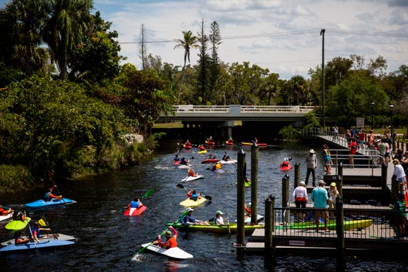 Boy Scouts from Troop 109 launch the kayaks they've been working on since September into the Imperial River at Riverside Park in Bonita Springs on Sunday, March 24, 2019.