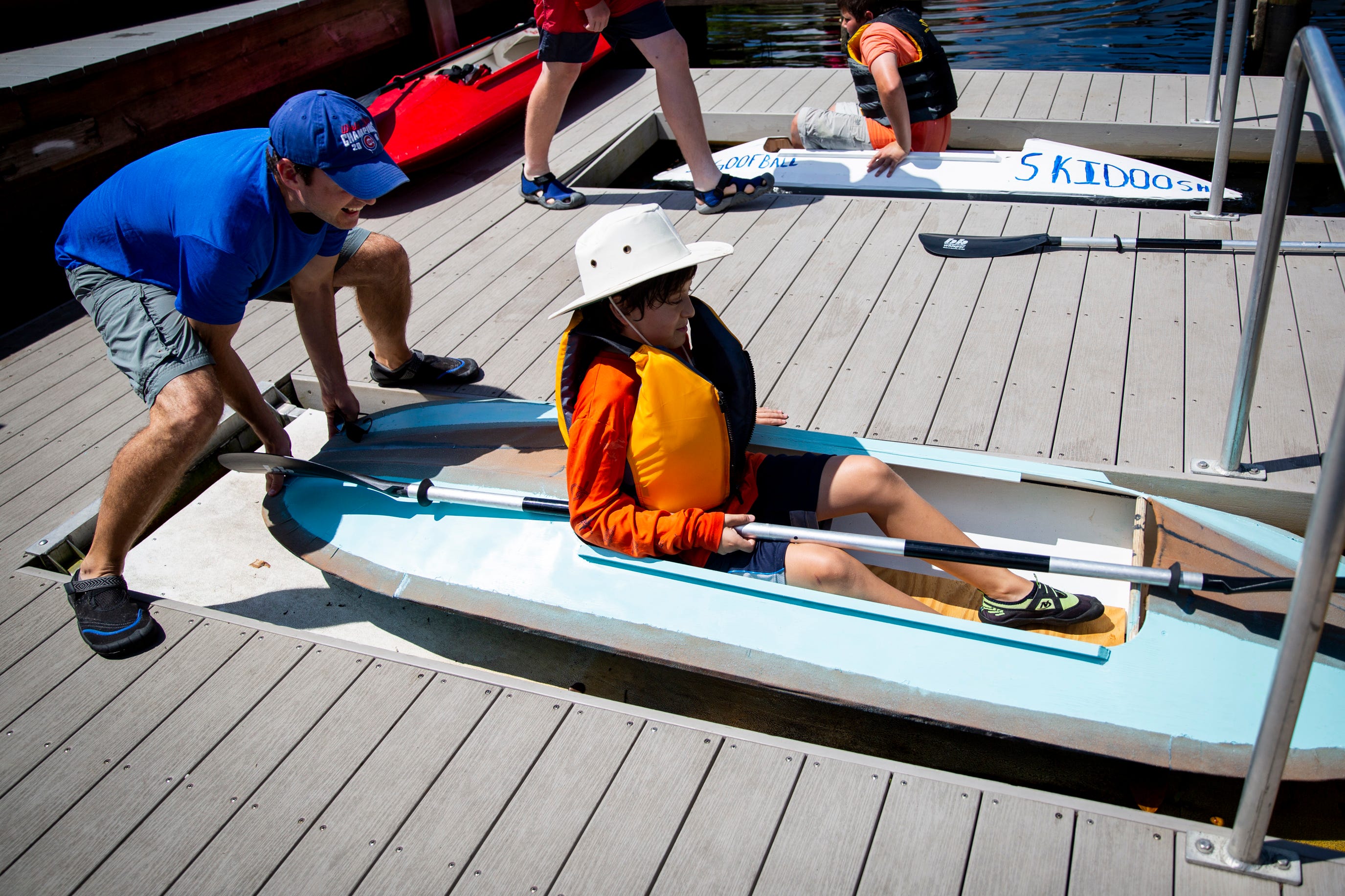 Jeff Gustin helps launch Julian Gustin's kayak into the Imperial River at Riverside Park in Bonita Springs on Sunday, March 24, 2019.