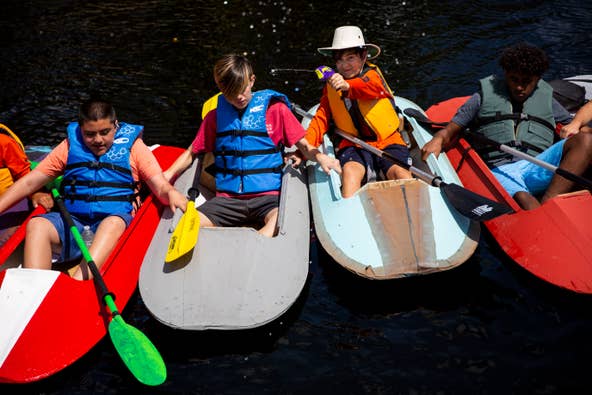 Julian Gustin shoots a water gun while he and other Boy Scouts from Troop 109 launch the kayaks they've been working on since September into the Imperial River at Riverside Park in Bonita Springs on Sunday, March 24, 2019.