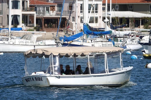 The electric Duffy boats line the Newport Beach Hartbor, home to multi-million dollar waterfront homes. The Duffys, which sell for $10,000 to $30,000, are also available for rent. Come join us on a photo cruise of the Hartbor, and let's explore Newport Beach as well.