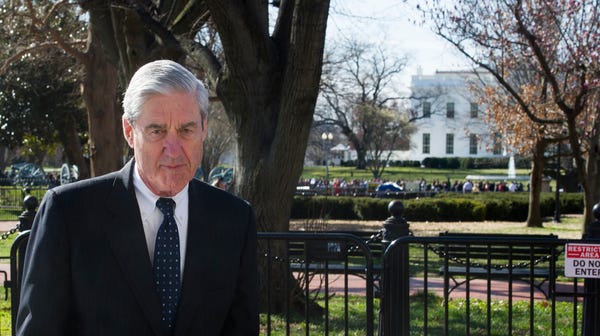 Special Counsel Robert Mueller walks past the...