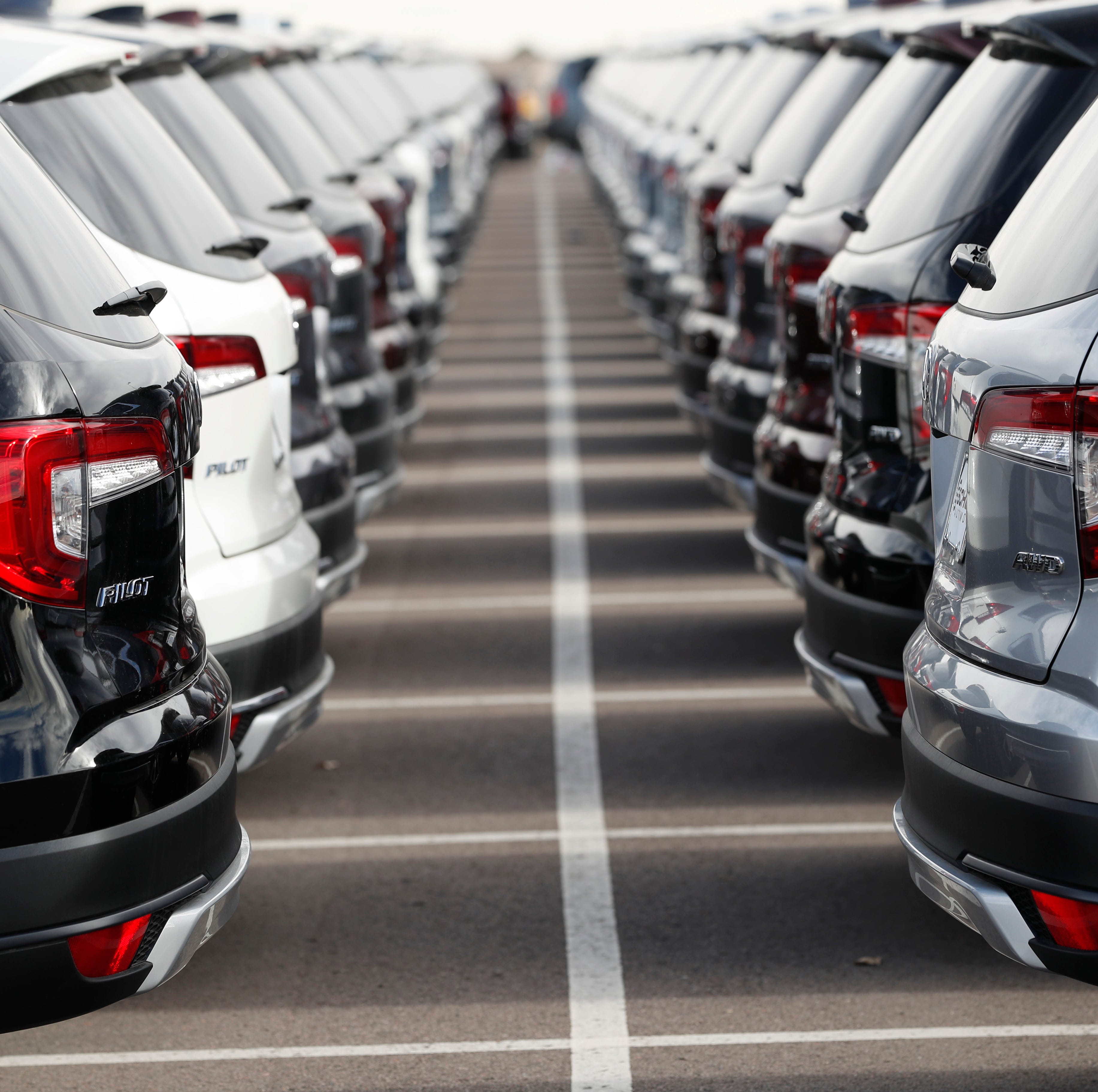 FILE -- In this Wednesday, Nov. 28, 2018, photograph, long lines of unsold 2019 Pilot sports-utility vehicles sit at a Honda dealership in Highlands Ranch, Colo.