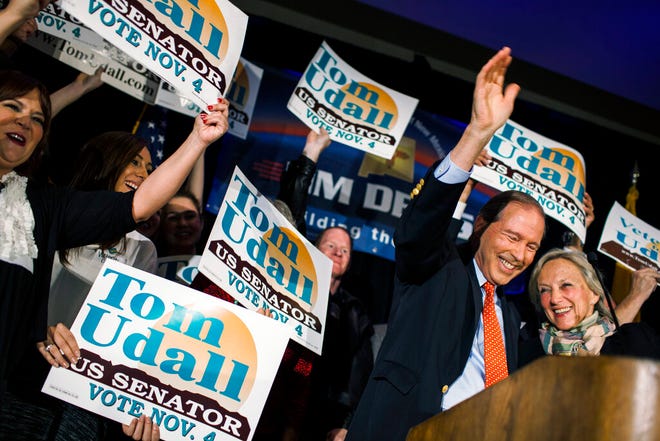 In this Nov. 4, 2014, file photo, Sen. Tom Udall, D-N.M., waves to supporters with his wife, Jill Cooper Udall, right, at the Double Tree hotel after being re-elected as one of New Mexico's Senators in Albuquerque, N.M. Udall says he will not seek re-election in 2020 in a move that opens up a secure Democratic seat to competition. He announced the end of his 20-year political career in Washington in a statement on Monday, March 25, 2019.