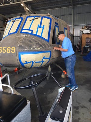 Joe Goebel, president of the Wayne County Veterans Memorial Park Committee, examines a UH-1 “Huey” helicopter to Richmond that will be displayed at Veterans Memorial Park.