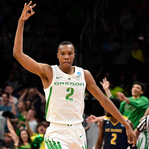 Louis King celebrates a three-point basket...