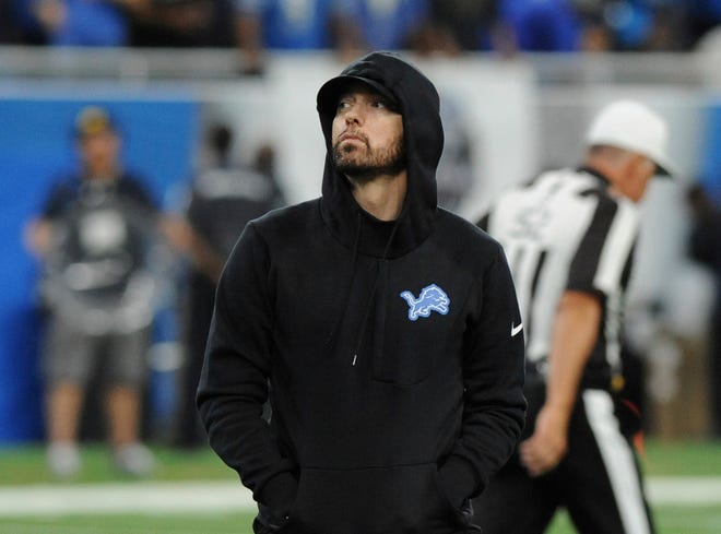 Eminem walks on the sidelines at Ford Field for a Lions game last September.