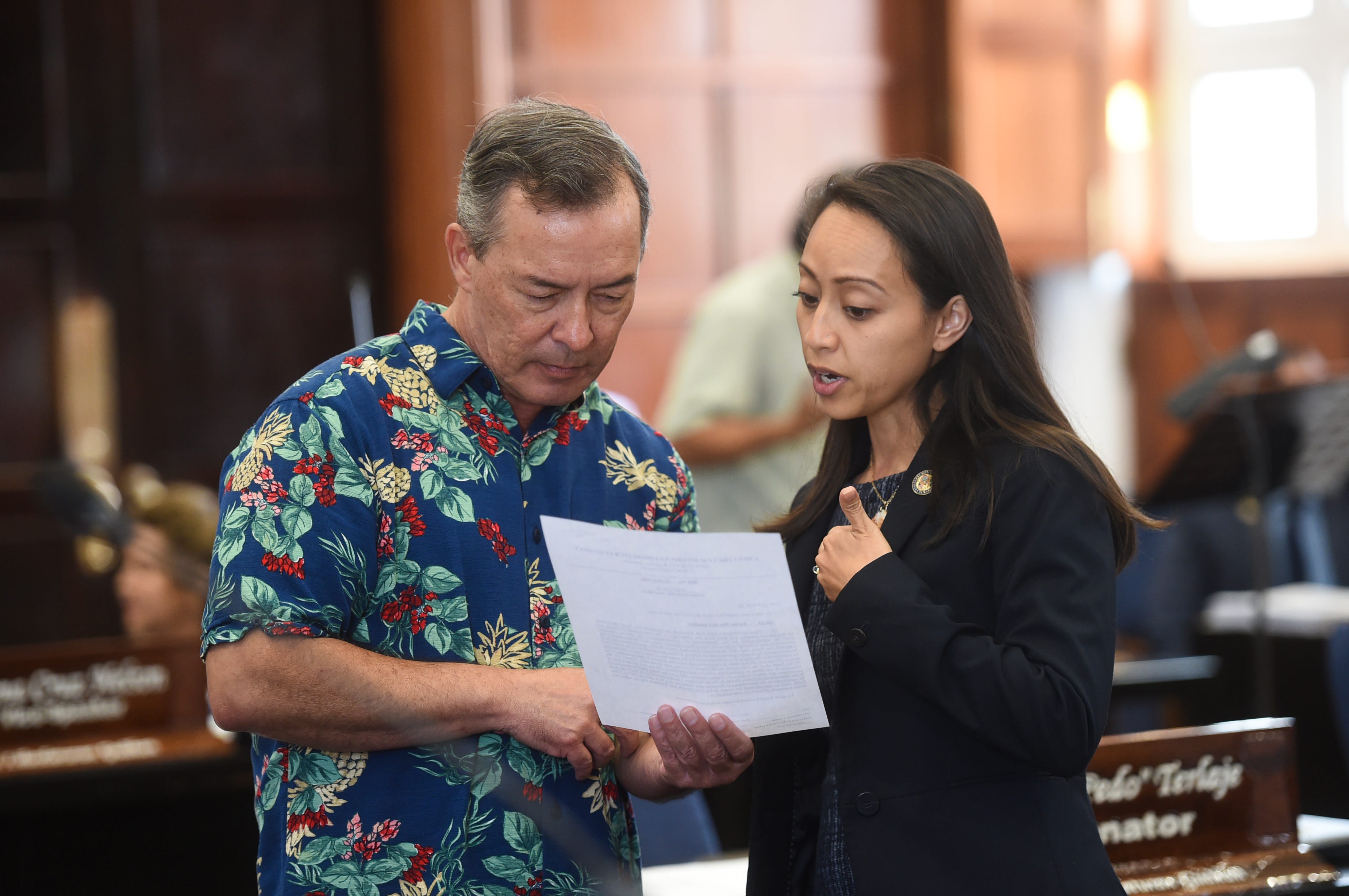 Sens. James C. Moylan and Regine Biscoe Lee during a session recess at the Guam Congress Building in Hagåtña, March 26, 2019.