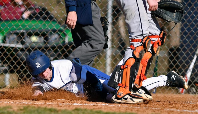 Dallastown's Riley Thomas slides past York Suburban catcher RJ Marquis to score in the second inning, Tuesday, March 26, 2019John A. Pavoncello photo