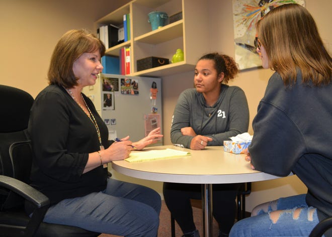 Former Washington High School counselor Patti Lake-Torbert talks with sophomores Angelique Kiyombo and Norilyn Binney about the stress of the upcoming standardized testing season Tuesday, March 26, 2019. Now the district's the district's senior coordinator of student support services, Lake-Torbert is helping the district prepare to offer in-person mental health services to students during the coronavirus pandemic when school starts  Aug. 27, 2020.
