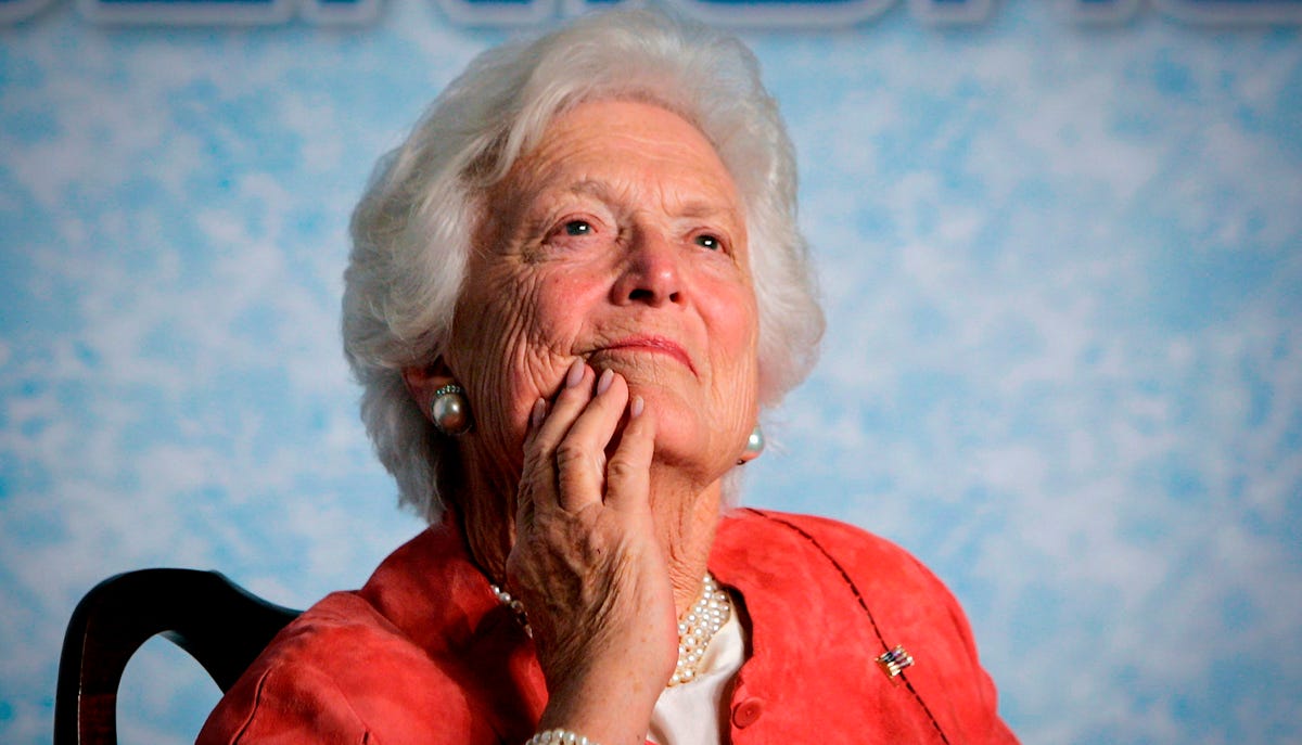 In this file photo from Friday, March 18, 2005, former first lady Barbara Bush listens to her son, President George W. Bush, as he speaks on Social Security reform in Orlando, Fla.