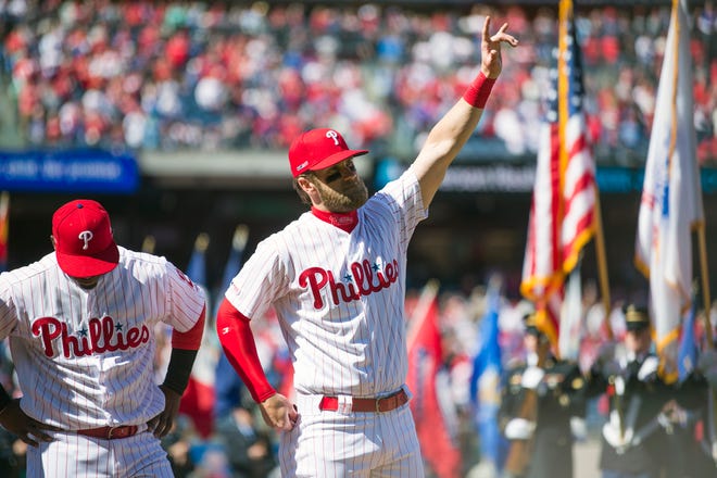 Bryce Harper gestures towards the crowd as he is introduced prior to the Phillies Opening Day game between the Phillies and the Braves at Citizens Bank Park in Philadelphia on Thursday, March 28, 2019.  