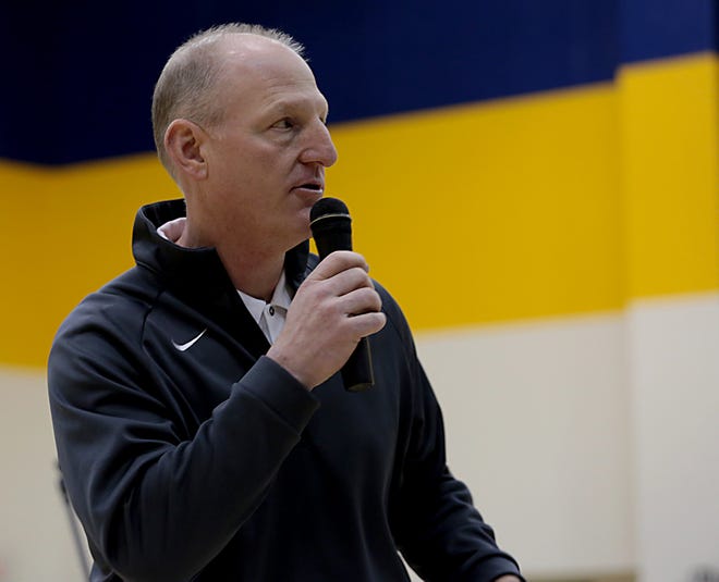 Moeller athletic director Mike Asbeck speaks to the student body during an assembly honoring the basketball team at the school in Cincinnati Thursday, March 28, 2019.