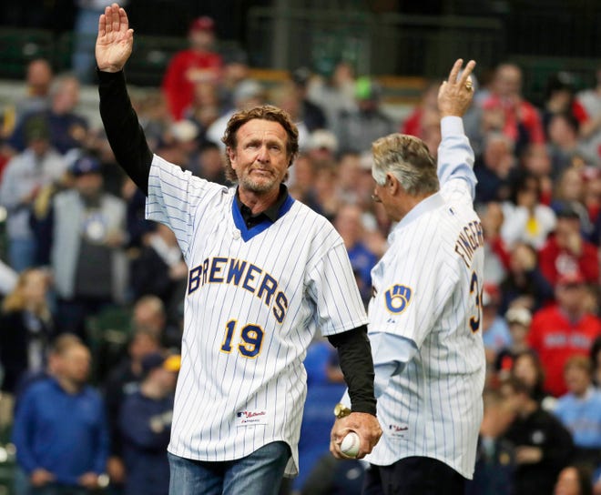 Robin Yount (left) and Rollie Fingers wave to fans before the ceremonial first pitch at opening day as the Milwaukee Brewers take on the. St. Louis Cardinals at Miller Park on Thursday.