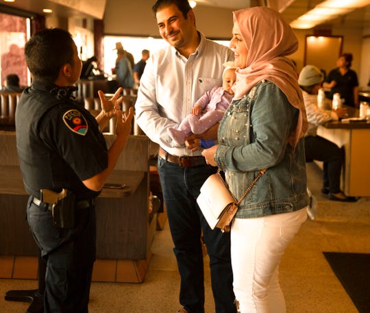 Las Cruces Police Officer Lt. Kiri Daines talks with Ayat Bataineh, Amer Al-Radaideh and four-month old Karima Al-Radaideh at Old Town Restaurant Thursday during Coffee with a Cop.