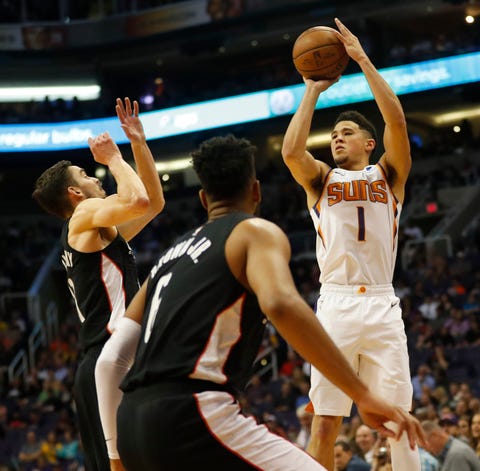 Phoenix Suns guard Devin Booker (1) attempts a...