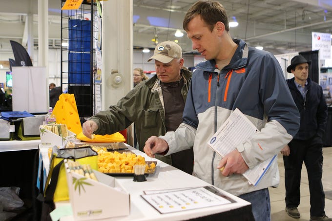 The line for cheese samples at Simon's Specialty Cheese was long but moved quickly at the Wisconsin Public Service Farm Show on March 27.