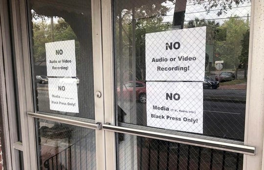 In this Wednesday, March 27, 2019 photo, signs posted on the doors of the Bolton Street Baptist Church are seen during a meeting coordinated to garner support for one black candidate in Savannah's mayoral race, in Savannah, Ga.